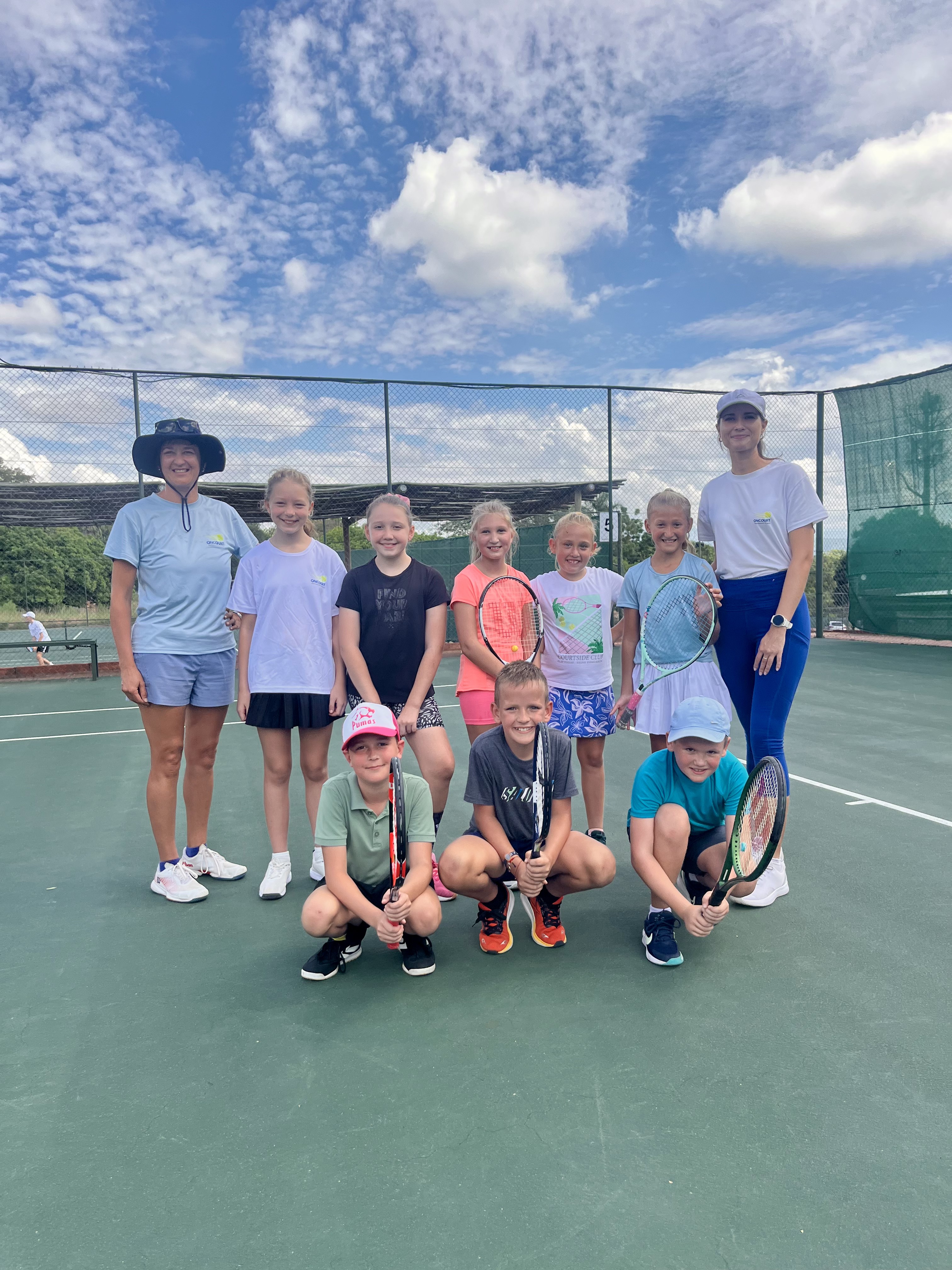 OnCourt coaches and junior tennis players at an academy session